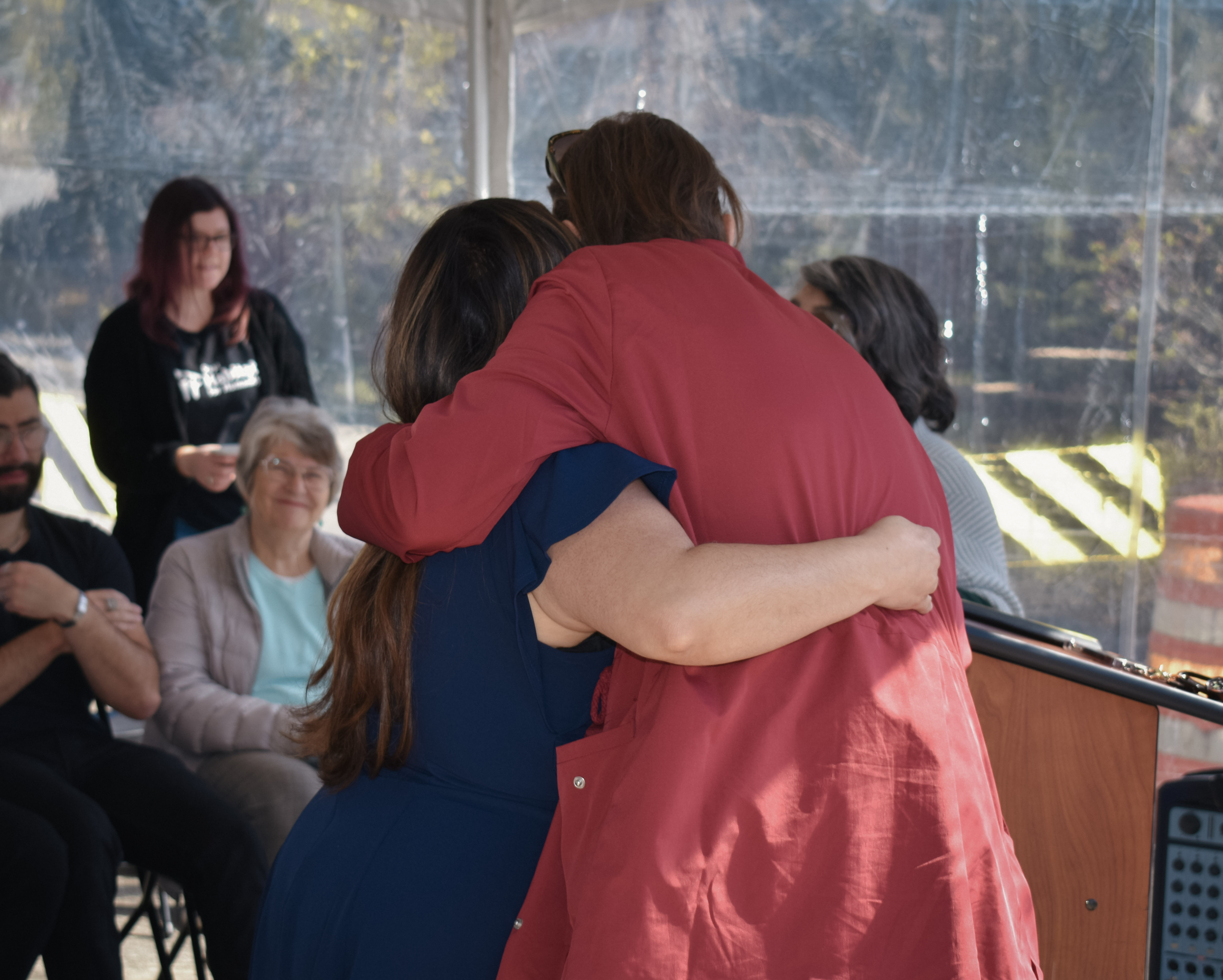 April hugging a Kendal Court homebuyer at a home dedication ceremony