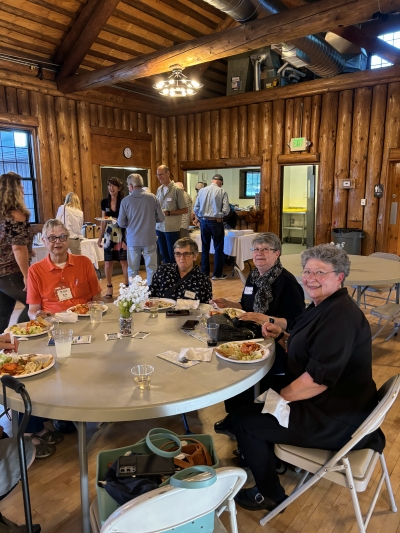 Group of Skagit Habitat for Humanity volunteers sitting around a table enjoying food at Volunteer Appreciation Night.