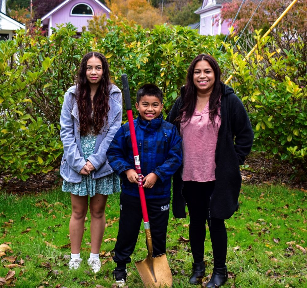 Homebuyer Program family, Rocio and her children standing on the construction site at Skagit habitat's groundbreaking ceremony