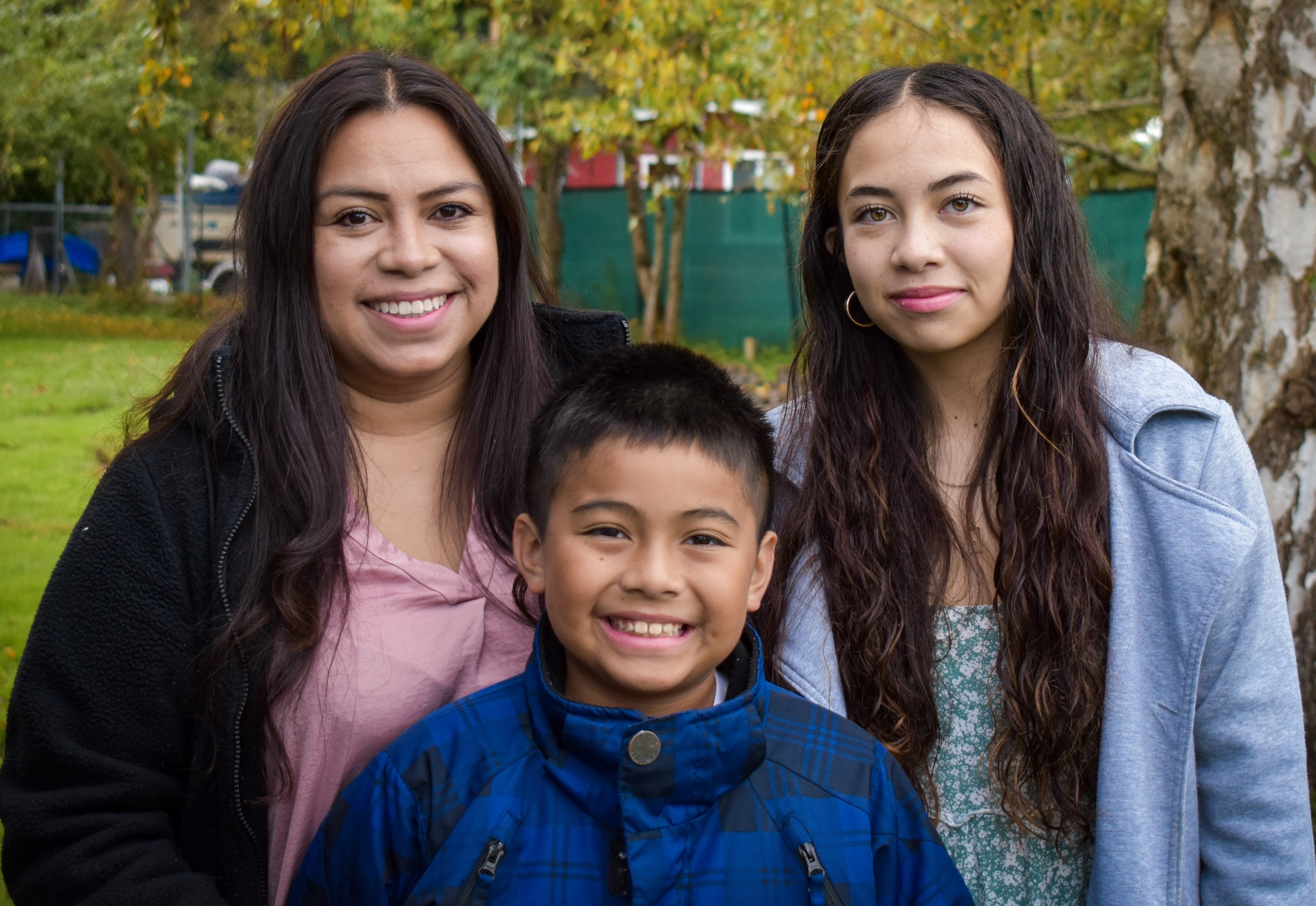 family smiling at the camera